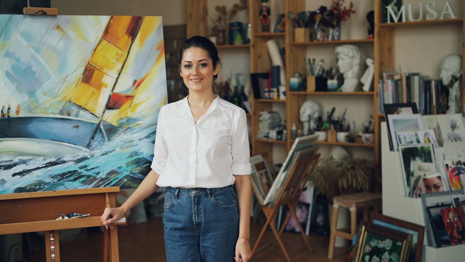 Artist in studio with vibrant sailboat painting, expressing creativity.