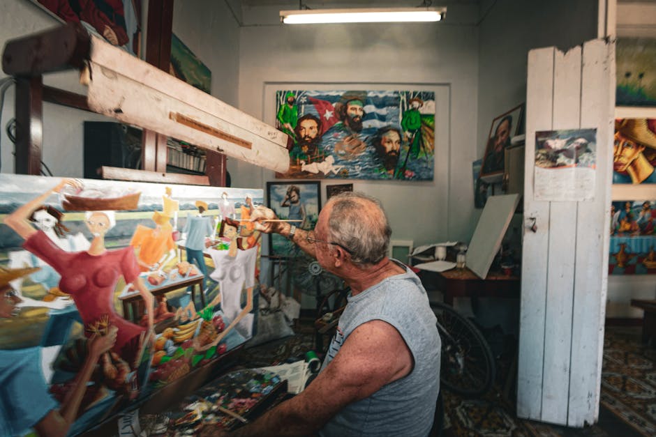 A male artist painting vibrant and colorful artwork in a rustic workshop.