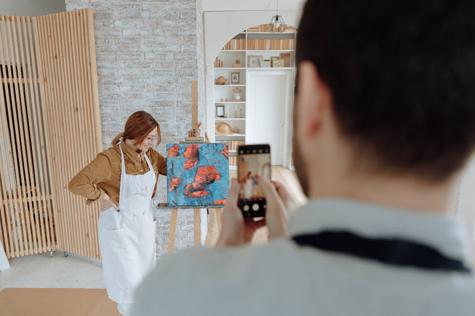 Creative artist posing with a colorful abstract painting in an indoor studio setting.